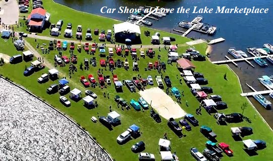 An aerial view of cars parked on a grassy open area