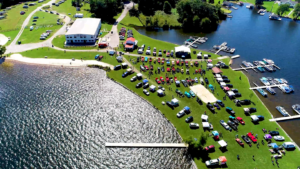 An aerial view of a lake with many cars parked on it.