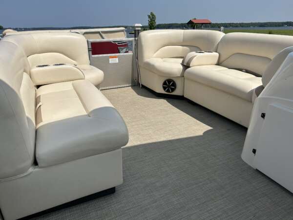 A couch and two chairs in the middle of a boat.