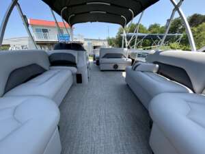 A boat with many couches and tables on the deck