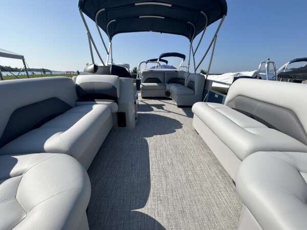 A boat with two couches and a table in the back.