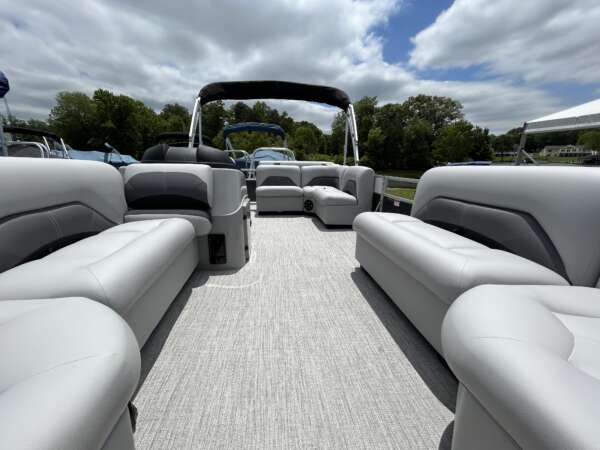 A boat with two couches and one table in the back.
