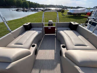 Beige pontoon boat interior with seating.