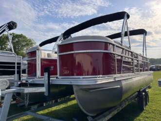 Red pontoon boat on a trailer.