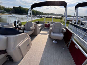 Tan pontoon boat with two seats.