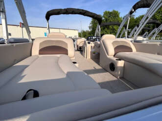 Beige pontoon boat with tan seats.