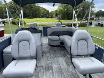 Gray pontoon boat seats with canopy.