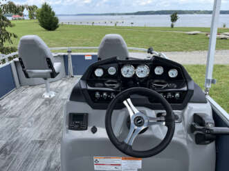 Pontoon boat interior with steering wheel.