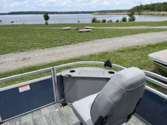 Grey boat seat overlooking lake.