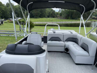 White pontoon boat with gray seats.