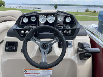 Boat steering wheel with gauges and controls.