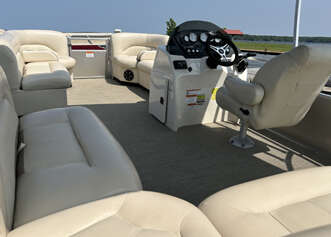 A white pontoon boat with seating.