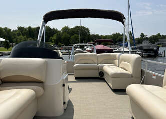 White pontoon boat with beige seating.