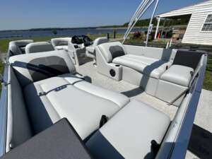 White pontoon boat seats with lake view.