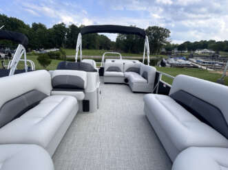 White pontoon boat with gray seating.