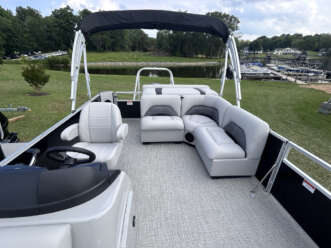 White pontoon boat with gray seats.