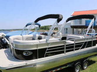 A black and silver pontoon boat.