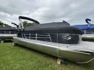 Silver and black pontoon boat on trailer.