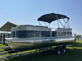 Silver pontoon boat on a trailer.