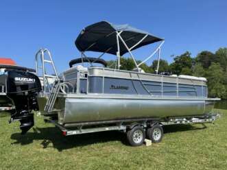 Silver Landau pontoon boat on trailer.