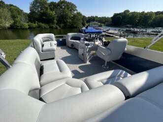 White pontoon boat with seating.