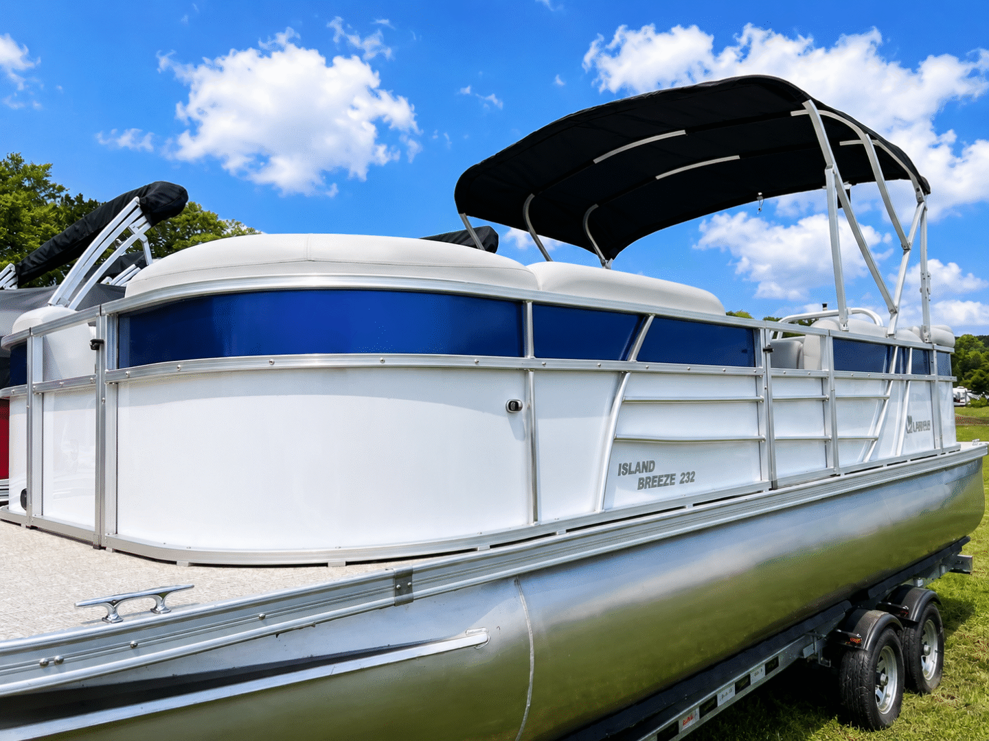 White and blue pontoon boat on trailer