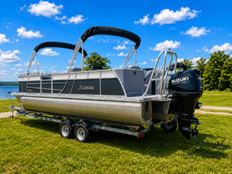 Pontoon boat on trailer by lake